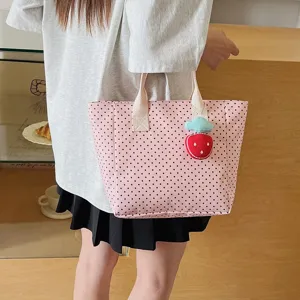 Pink polka dot tote bag with strawberry charm and large capacity for daily commute