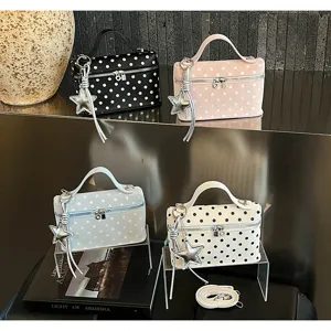 Four stylish polka dot box handbags with star charms and adjustable white shoulder strap.