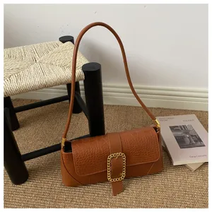 Detailed view of the brown stone-patterned French baguette shoulder bag.
