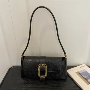 Elegant black stone pattern baguette shoulder bag for women with gold chain buckle detail.