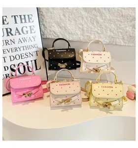 Collection of colorful polka dot handbags with belt buckle detail and top handles