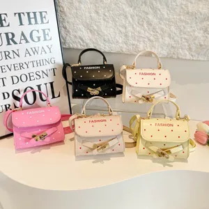 Collection of polka dot crossbody handbags in multiple colors with belt buckle detail