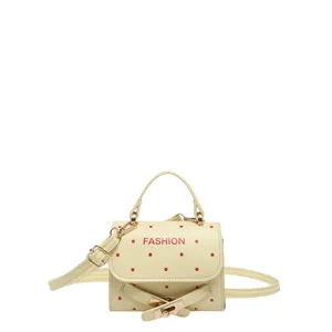 Cute cream crossbody handbag with red polka dots and fashion belt buckle detail