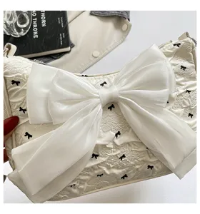 Detailed macro view of the crinkled bubble gauze texture and large decorative white bow.