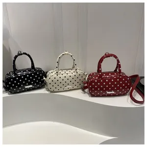 Stylish vintage polka dot oval handbags displayed in black, cream, and red colors