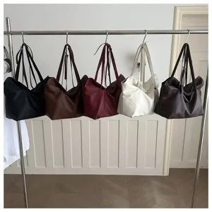 Large capacity tote bags in five different colors hanging on a rack