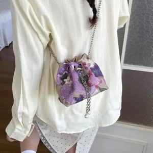 Vintage style bucket bag with heavy floral embroidery and sequins on a chain strap
