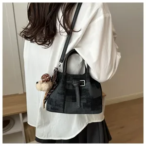 Casual lifestyle view of the vintage patterned bucket bag with dog charm