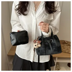 Asian model showcasing a stylish vintage 2-piece bucket bag set featuring a cute teddy bear charm