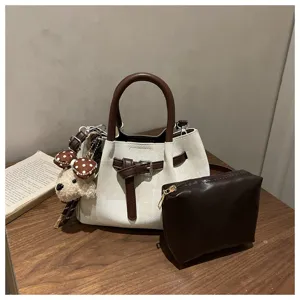 Retro two-piece bucket bag set featuring a brown clutch and plush teddy bear charm