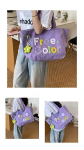 Casual purple canvas tote bag with embroidered letters and cute flower pendant for daily use.