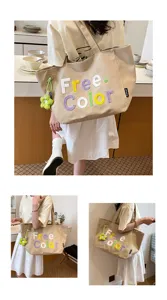 Casual canvas tote bag for women, stylish shoulder handbag with cute flower charm and letter embroidery.