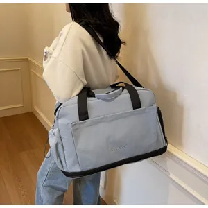 Detail view of the light blue travel duffel bag showing durable fabric and sturdy straps.