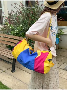 Colorful colorblock travel duffel bag with large capacity, ideal for gym, sports and trips.