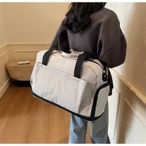 Detailed view of large capacity travel duffel bag showing sturdy straps and durable gray fabric.