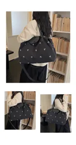 Large capacity nylon travel bag for women with cute bow embroidery and shoulder strap.