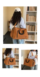 Detailansicht der braunen Reisetasche mit robusten Griffen und geräumigem Staufach.