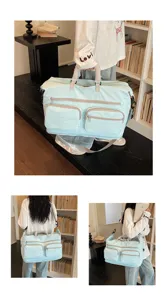 Large capacity travel duffel bag detail, light blue lightweight shoulder bag for business trips.