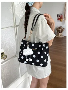 Detailed view of the large capacity polka dot tote bag with a cute cloud charm.