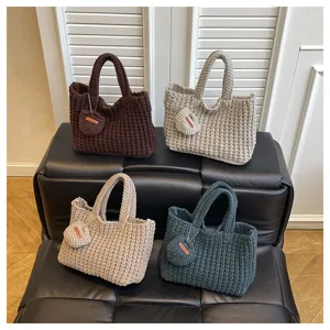 Sacs à main tricotés à la main en quatre couleurs avec breloques en forme de cœur.