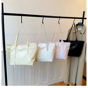 Close-up detail of large capacity commuting tote bags in four colors hanging on a rack