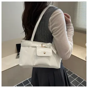 Detail of a white vintage tote shoulder bag in soft leather carried by an Asian model