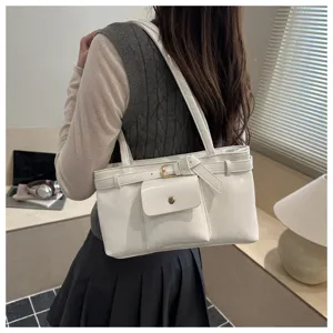Stylish white vintage tote bag with buckle detail and front pocket worn by model