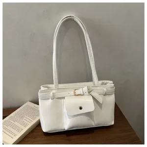 Detailed view of a white vintage-style tote bag with soft texture and buckle accent.