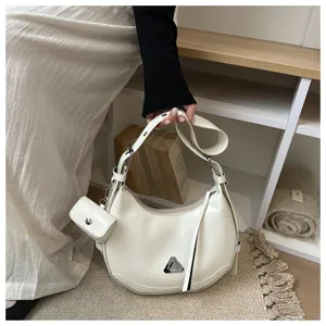 Close-up of stylish white crescent hobo bag with detachable mini pouch detail.