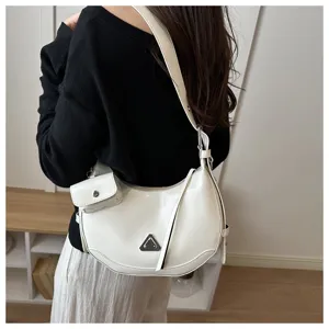 Detailed side view of a stylish white crescent hobo bag with a small attached coin pouch