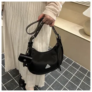 Black crescent hobo bag for women featuring a sleek motorcycle style with mini pouch