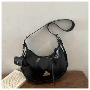 Modern black crescent shoulder bag featuring motorcycle design and a detachable mini pouch