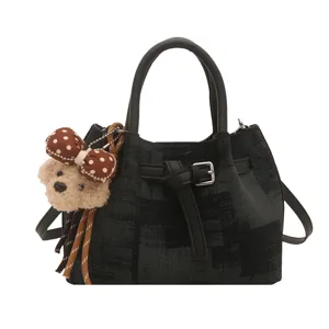 Vintage dark textured bucket bag with cute bear charm and adjustable shoulder strap