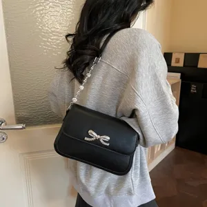 Elegante schwarze Umhängetasche für Damen mit Strass-Schleife und Kristallgurt