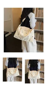 Canvas travel bag with leather flap and bow embroidery for short trips and daily use.
