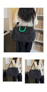 Detailed view of the large capacity black travel duffel bag with green handles in indoor scene