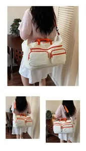 Large capacity canvas travel duffel bag with orange trim and multi-pockets for gym trip.