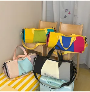 Close-up view of multiple vibrant color-blocked duffel bags for travel and gym use.