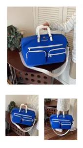 Close-up view of blue travel duffel bag showing white straps and multiple front pockets.