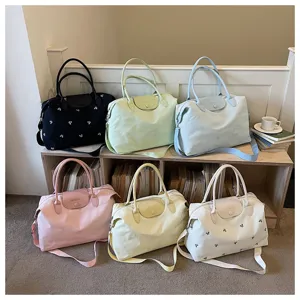 Large capacity travel duffel bag for women, lightweight canvas weekender bag with shoulder strap.