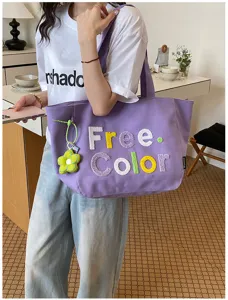 Korean style purple canvas tote bag with cute flower pendant, casual fashion shoulder handbag.