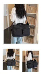 Large capacity black travel duffel bag with multi-pockets and shoulder strap for fitness.