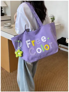 Literary style purple canvas tote bag with embroidered letters and cute flower pendant design.