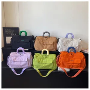 Multiple color travel duffel bags display detail showing large capacity and handy front pockets.