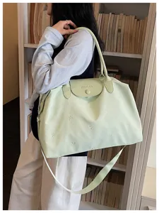 Lightweight large capacity travel duffel bag for women, stylish embroidered bow design.