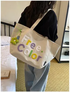 Casual canvas tote bag for women, minimalist shoulder bag with cute embroidered letters.