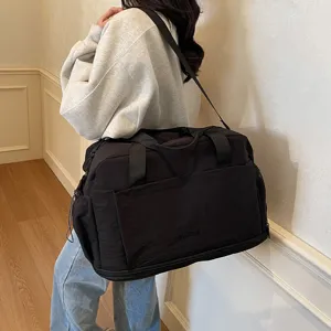 Large capacity black travel duffel bag with shoulder strap, ideal for short trips and gym.