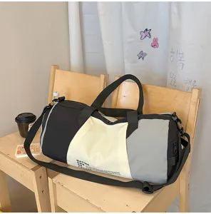 Stylish color-blocked travel duffel bag with large capacity, ideal for gym and weekend trips.