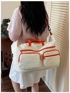 Large capacity travel duffel bag with multiple pockets and orange zippers for gym and trips.