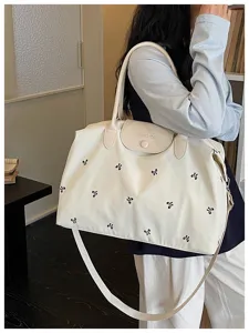 Large capacity travel duffel bag with cute bow embroidery for women short trips daily use.